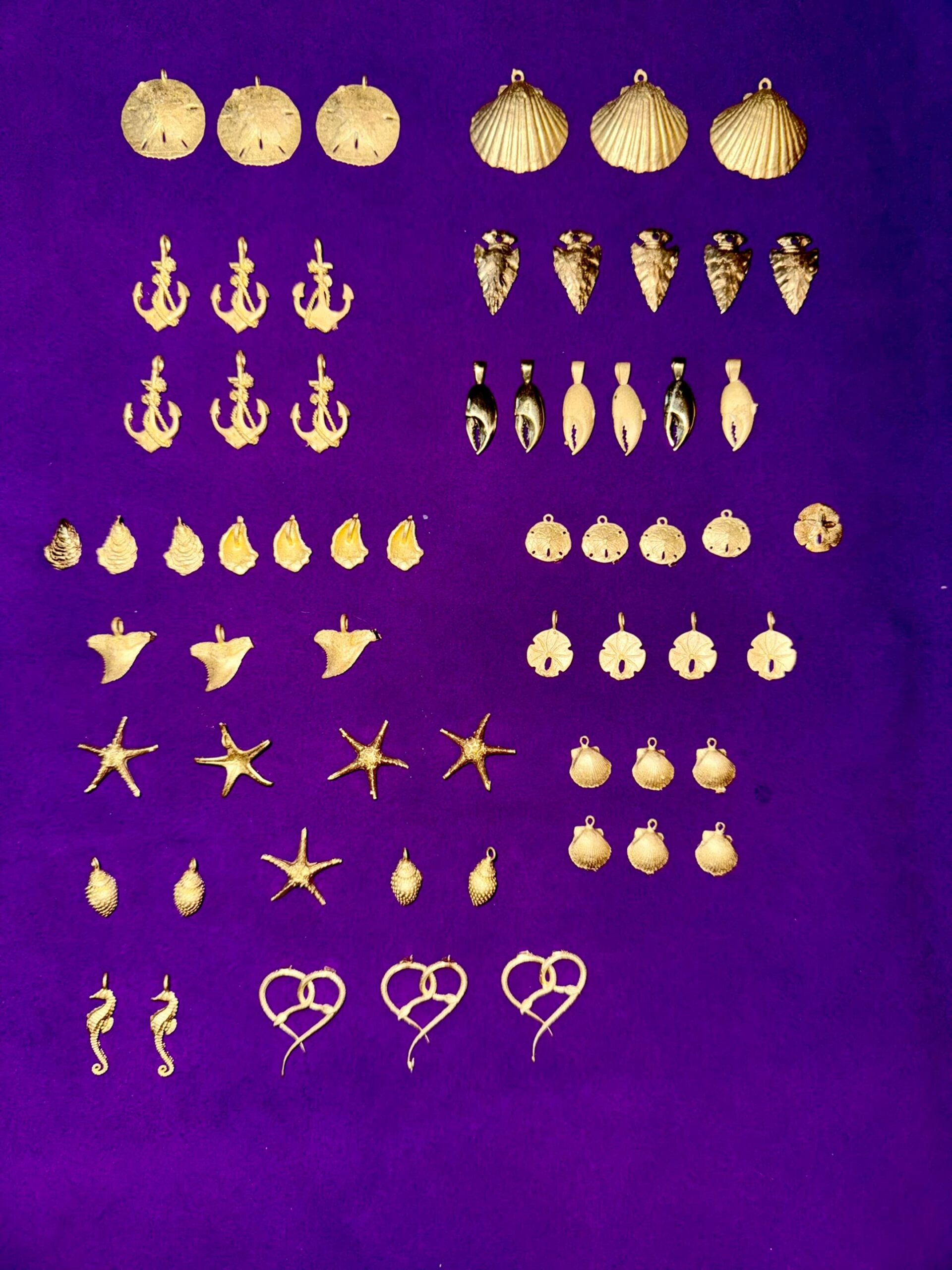 Various gold pendants created by Jake Piskura